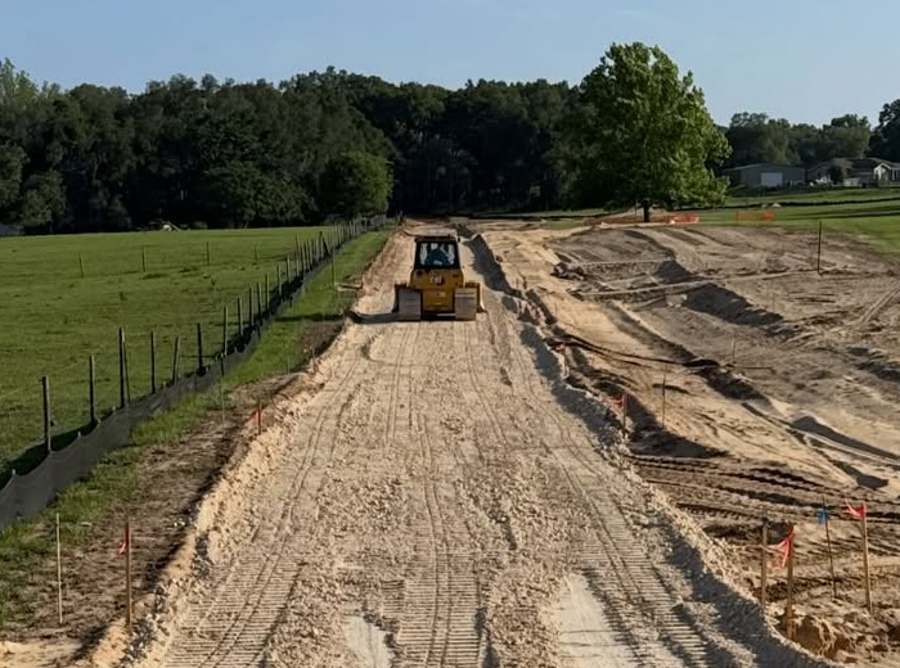Dozer grading a new road on a cleared Florida site
