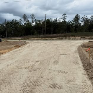 Compacted road base cut through a wooded lot